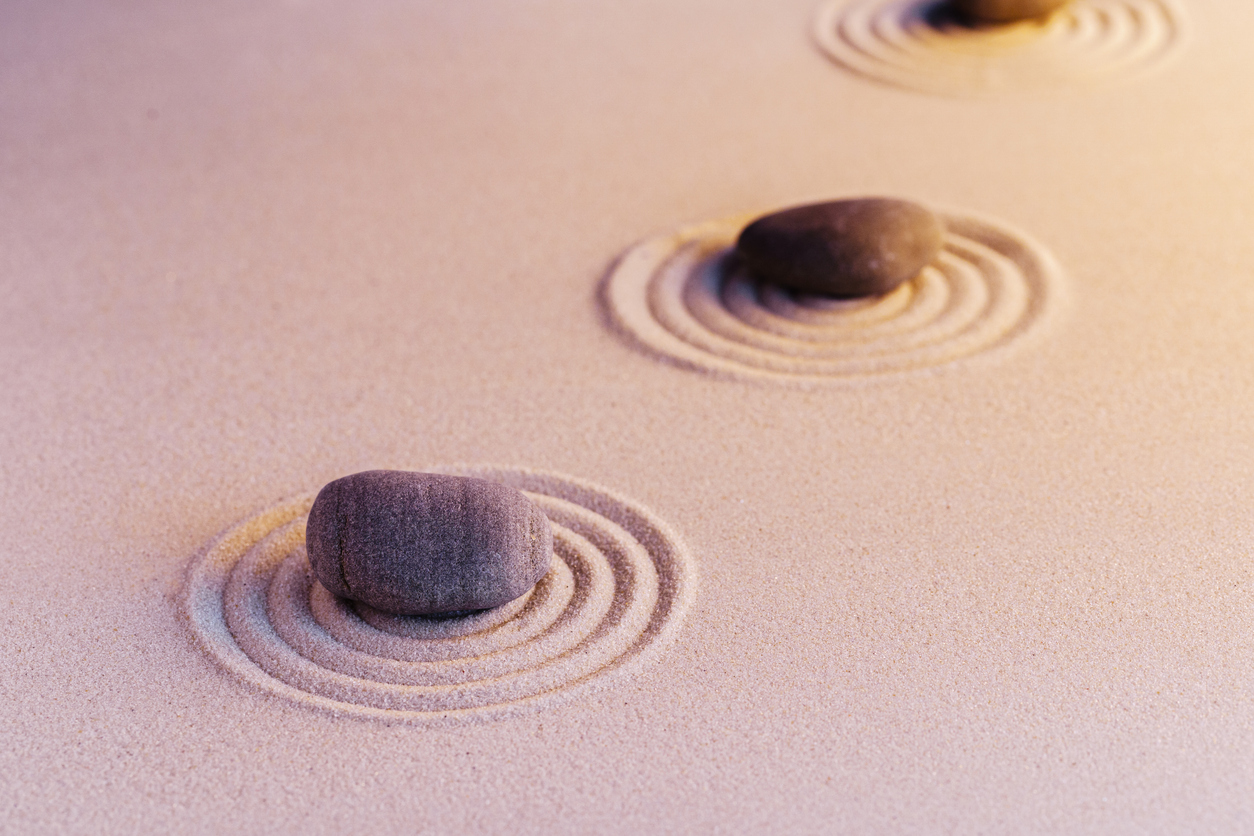 Zen garden stones on sand with ornament